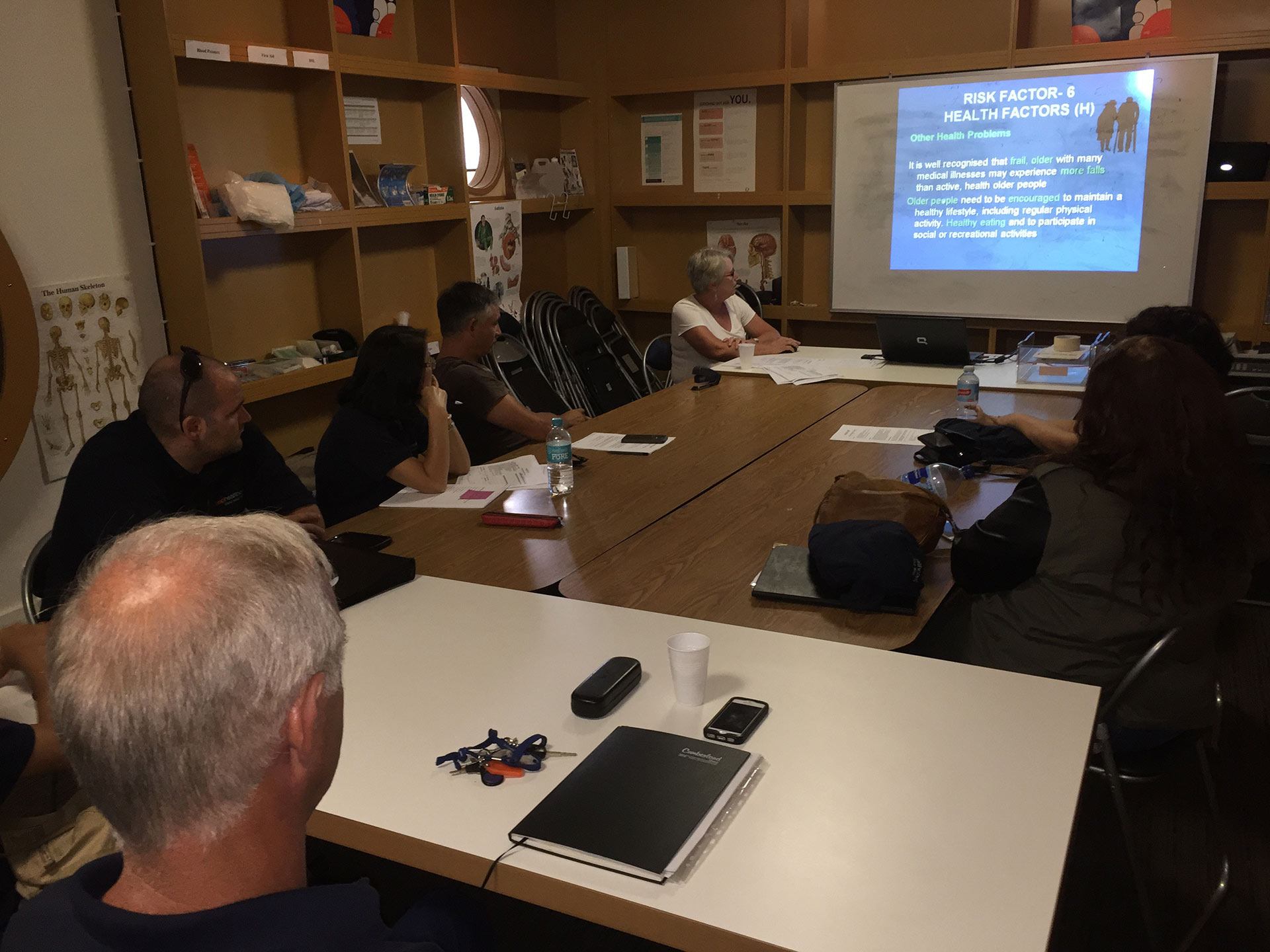 A Group Of People Sitting Around Looking At The Presentation - Sydney Home Care - ESP Healthcare